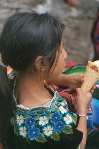 guatemala, picture 12: girl eating ice cream, chichicastenango. click on the image to go to the next picture
